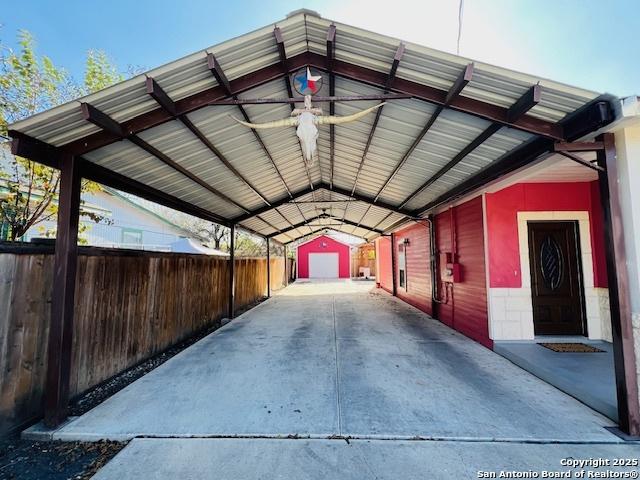 view of vehicle parking with a carport