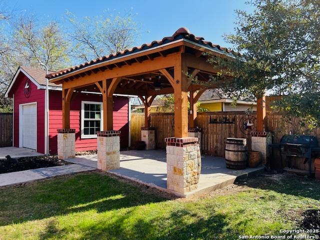 view of patio / terrace with a gazebo, area for grilling, and a garage