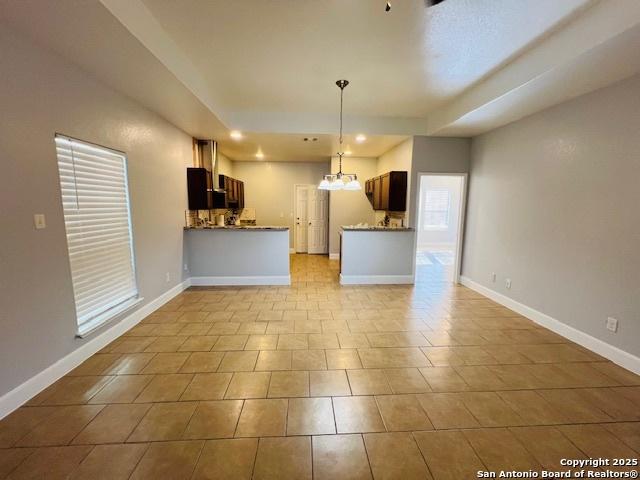 kitchen featuring kitchen peninsula and pendant lighting