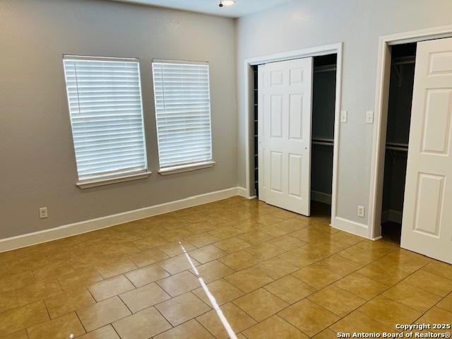 unfurnished bedroom with light tile patterned flooring