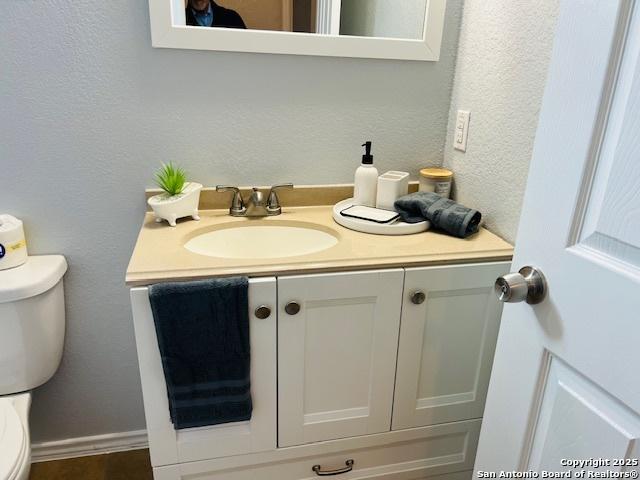 bathroom with vanity and toilet