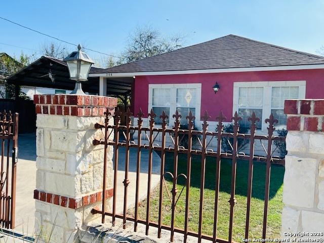 view of gate with a lawn