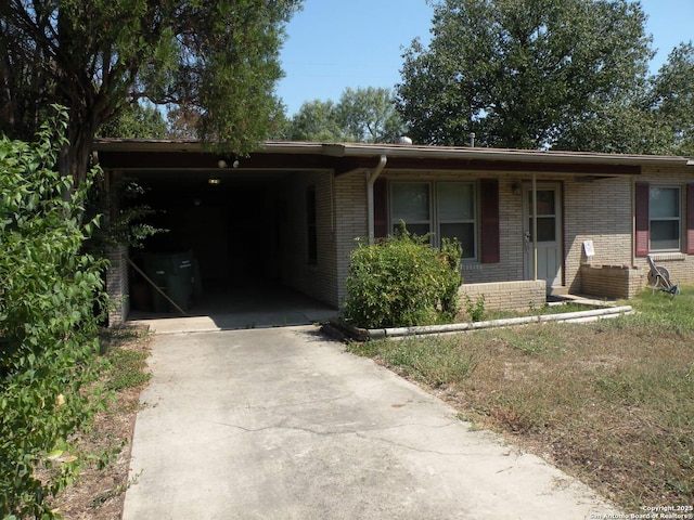 ranch-style house featuring a carport