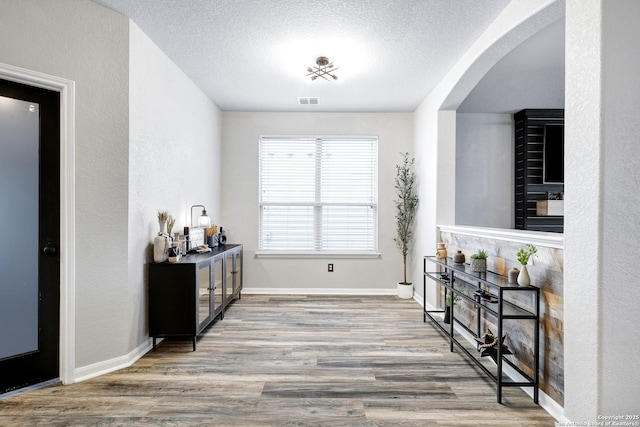 sitting room featuring hardwood / wood-style floors and a textured ceiling