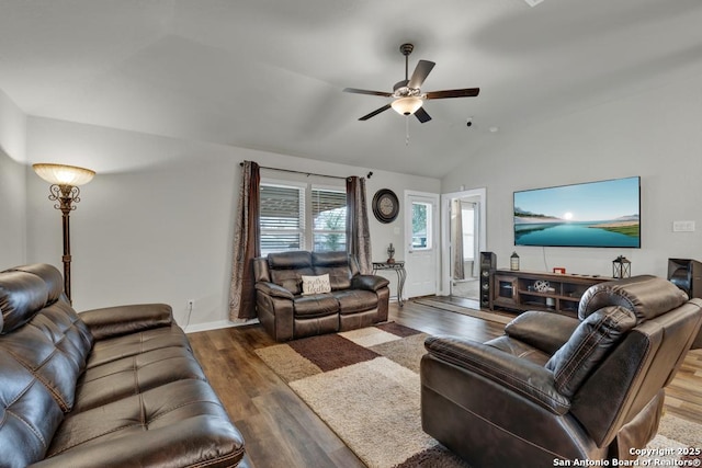 living room featuring dark hardwood / wood-style flooring, vaulted ceiling, and ceiling fan