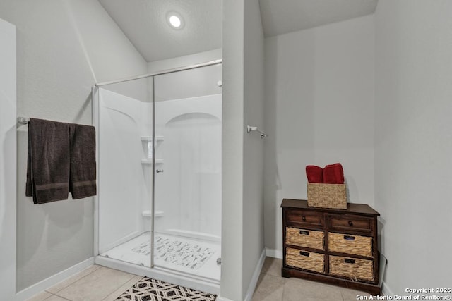 bathroom featuring tile patterned flooring and an enclosed shower