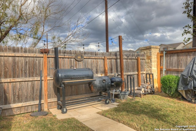 deck featuring a lawn and area for grilling