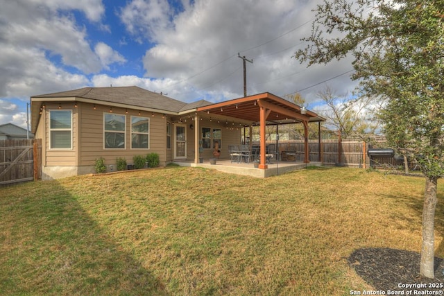 back of property with a patio area and a lawn