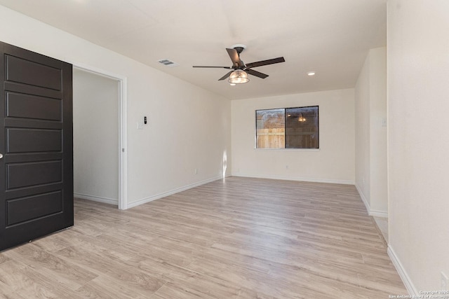 empty room with ceiling fan and light wood-type flooring