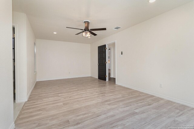 spare room featuring ceiling fan and light wood-type flooring