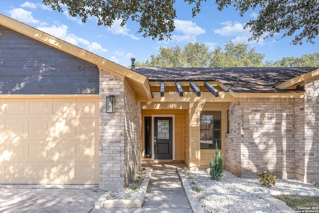 doorway to property with a garage