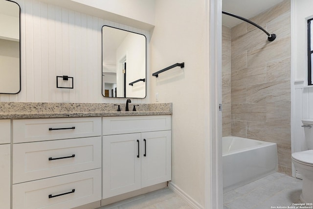 full bathroom featuring tile patterned flooring, vanity, toilet, and tiled shower / bath combo