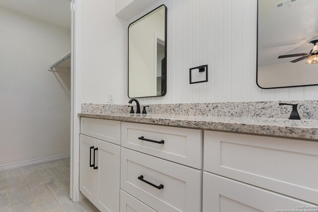 bathroom with ceiling fan and vanity