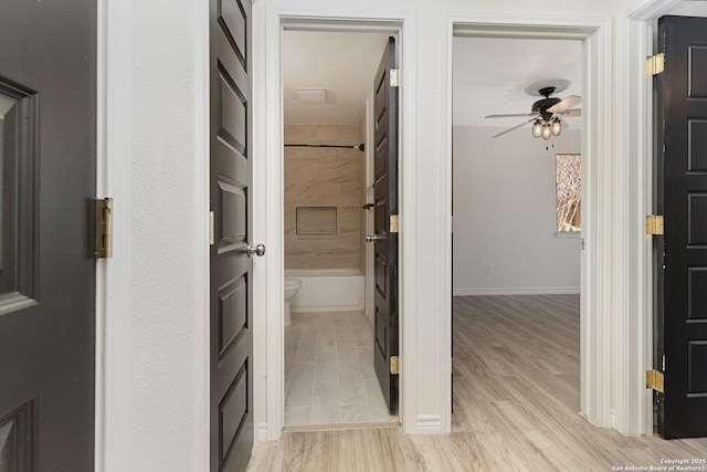 hallway with light hardwood / wood-style flooring