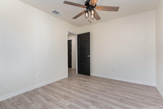 spare room featuring ceiling fan and light hardwood / wood-style floors