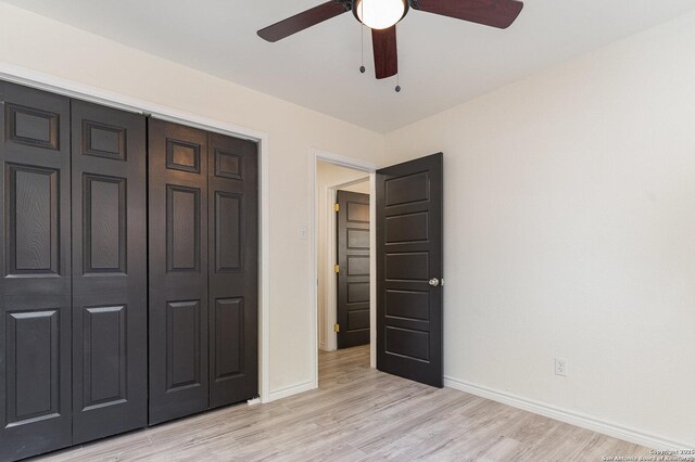 unfurnished bedroom featuring light wood-type flooring, a closet, and ceiling fan