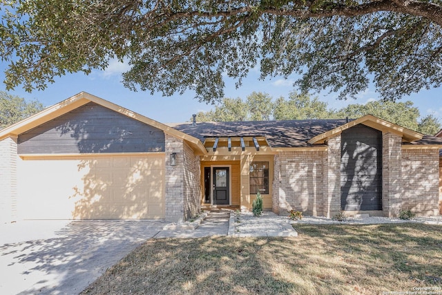 ranch-style house featuring a garage and a front yard