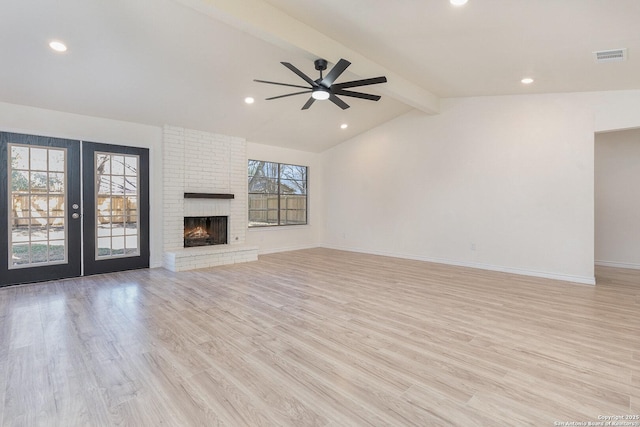 unfurnished living room featuring ceiling fan, french doors, lofted ceiling with beams, and light hardwood / wood-style floors