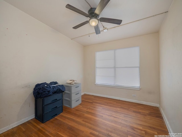 interior space featuring ceiling fan and dark hardwood / wood-style flooring