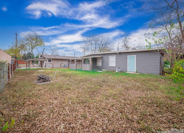 rear view of house with a yard