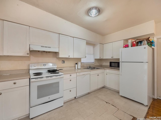 kitchen with a textured ceiling, white appliances, sink, white cabinets, and range hood