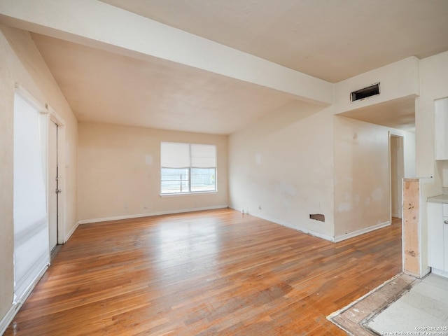 unfurnished room with light wood-type flooring