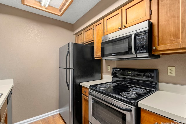 kitchen with light wood-type flooring and stainless steel appliances