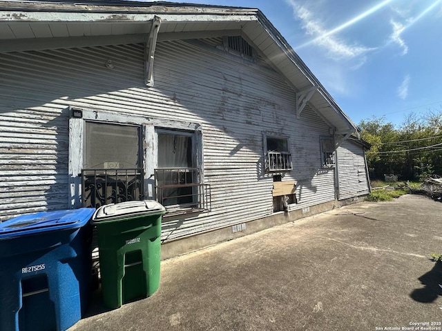 view of side of home with a patio area