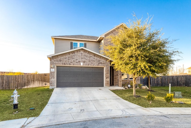 view of front of property with a garage and a front yard