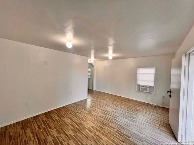 unfurnished room featuring cooling unit and light wood-type flooring