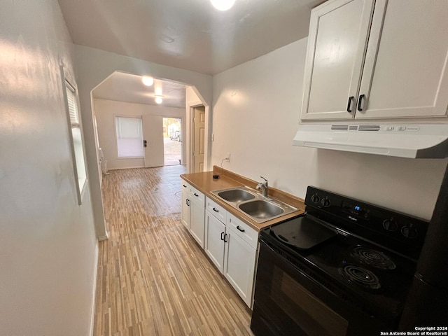 kitchen with electric range, sink, light hardwood / wood-style flooring, extractor fan, and white cabinets