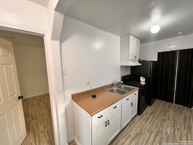 kitchen featuring white cabinetry, sink, black range with electric cooktop, exhaust hood, and light wood-type flooring