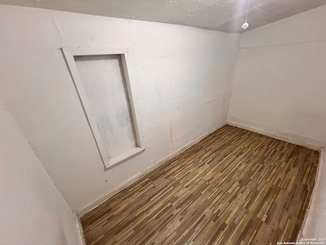 unfurnished room featuring dark hardwood / wood-style flooring