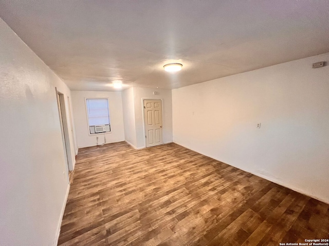 spare room featuring cooling unit and wood-type flooring