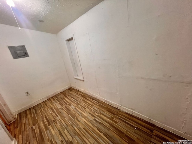 empty room featuring hardwood / wood-style floors and electric panel