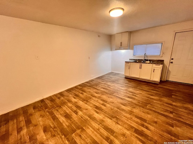 kitchen featuring sink, white cabinets, and hardwood / wood-style floors