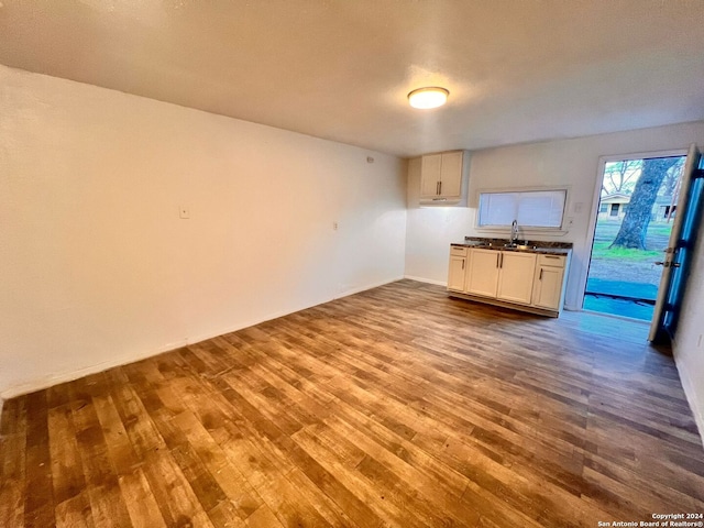 kitchen featuring white cabinetry, sink, and hardwood / wood-style flooring