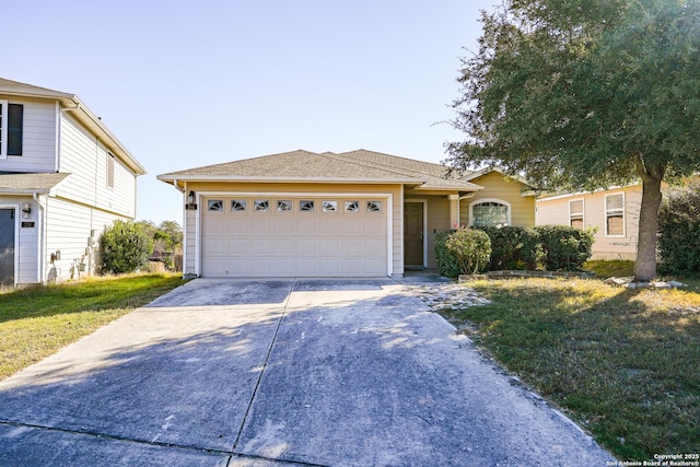 view of front of property featuring a front yard and a garage