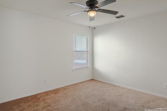 spare room with ceiling fan and light colored carpet