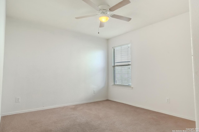 unfurnished room with ceiling fan and light colored carpet