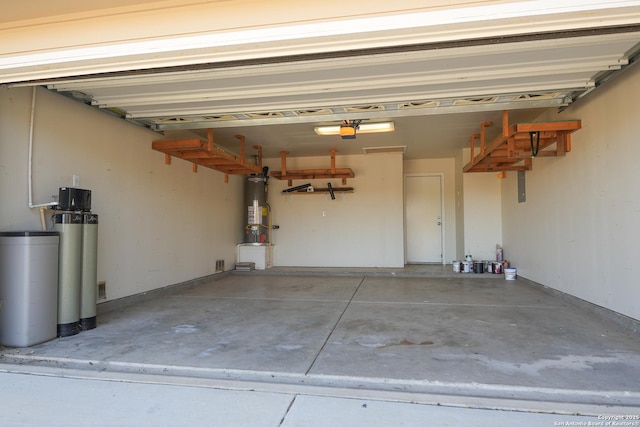 garage featuring a garage door opener and water heater