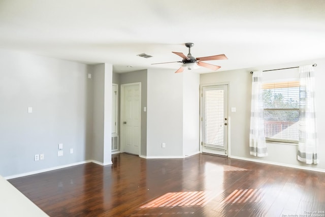 spare room with dark hardwood / wood-style floors and ceiling fan