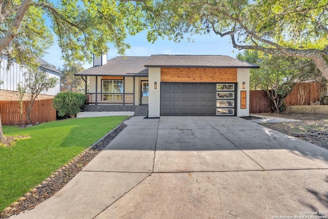 view of front of property with a porch, a garage, and a front yard