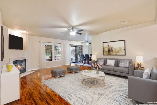 living room featuring hardwood / wood-style flooring and ceiling fan