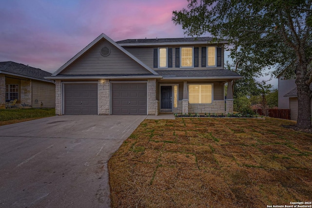 view of front of property featuring a garage and a yard