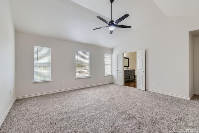 unfurnished bedroom featuring carpet flooring, connected bathroom, ceiling fan, and lofted ceiling