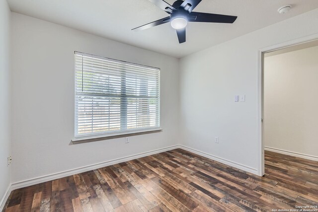 spare room featuring dark hardwood / wood-style floors and ceiling fan