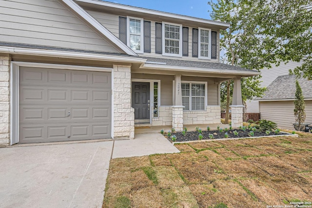 view of front of home featuring a front yard, a porch, and a garage