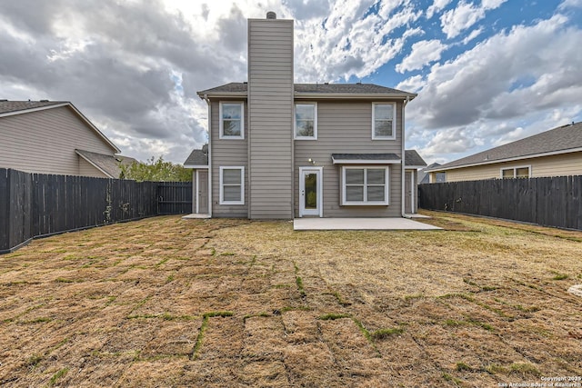 rear view of house featuring a yard and a patio area