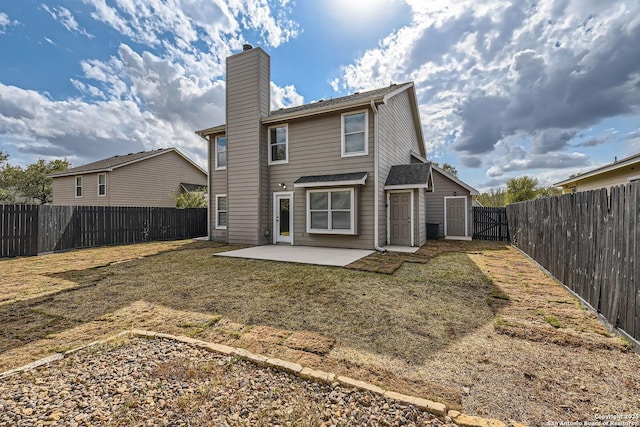 rear view of house with a lawn and a patio area